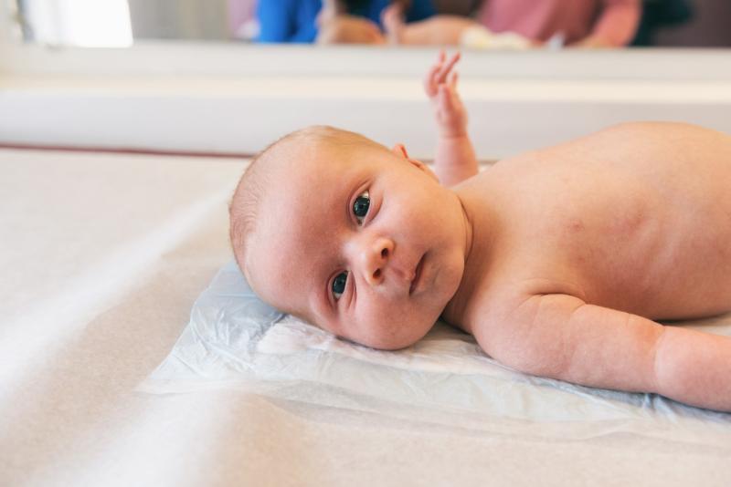 a baby on an exam table